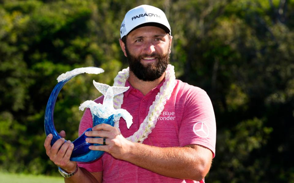 Jon Rahm, of Spain, holds the champions trophy after the final round of the Tournament of Champions golf event, Sunday, Jan. 8, 2023, at Kapalua Plantation Course in Kapalua, Hawaii - AP Photo/Matt York