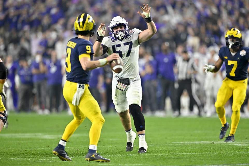 GLENDALE, ARIZONA - DECEMBER 31: Linebacker Johnny Hodges #57 of the TCU Horned Frogs pressures quarterback J.J. McCarthy #9 of the Michigan Wolverines during the third quarter of the College Football Playoff Semifinal Fiesta Bowl football game at State Farm Stadium on December 31, 2022 in Glendale, Arizona. The TCU Horned Frogs won 51-45. (Photo by Alika Jenner/Getty Images)