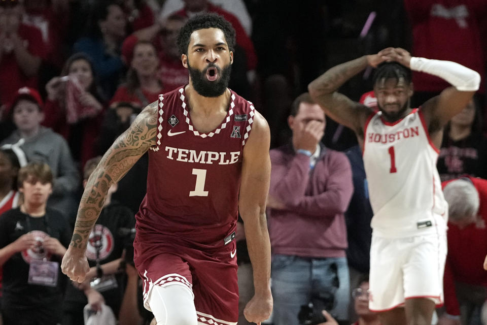 Temple's Damian Dunn, left, celebrates as Houston's Jamal Shead, right, reacts at the end an NCAA college basketball game Sunday, Jan. 22, 2023, in Houston. Temple won 56-55. (AP Photo/David J. Phillip)