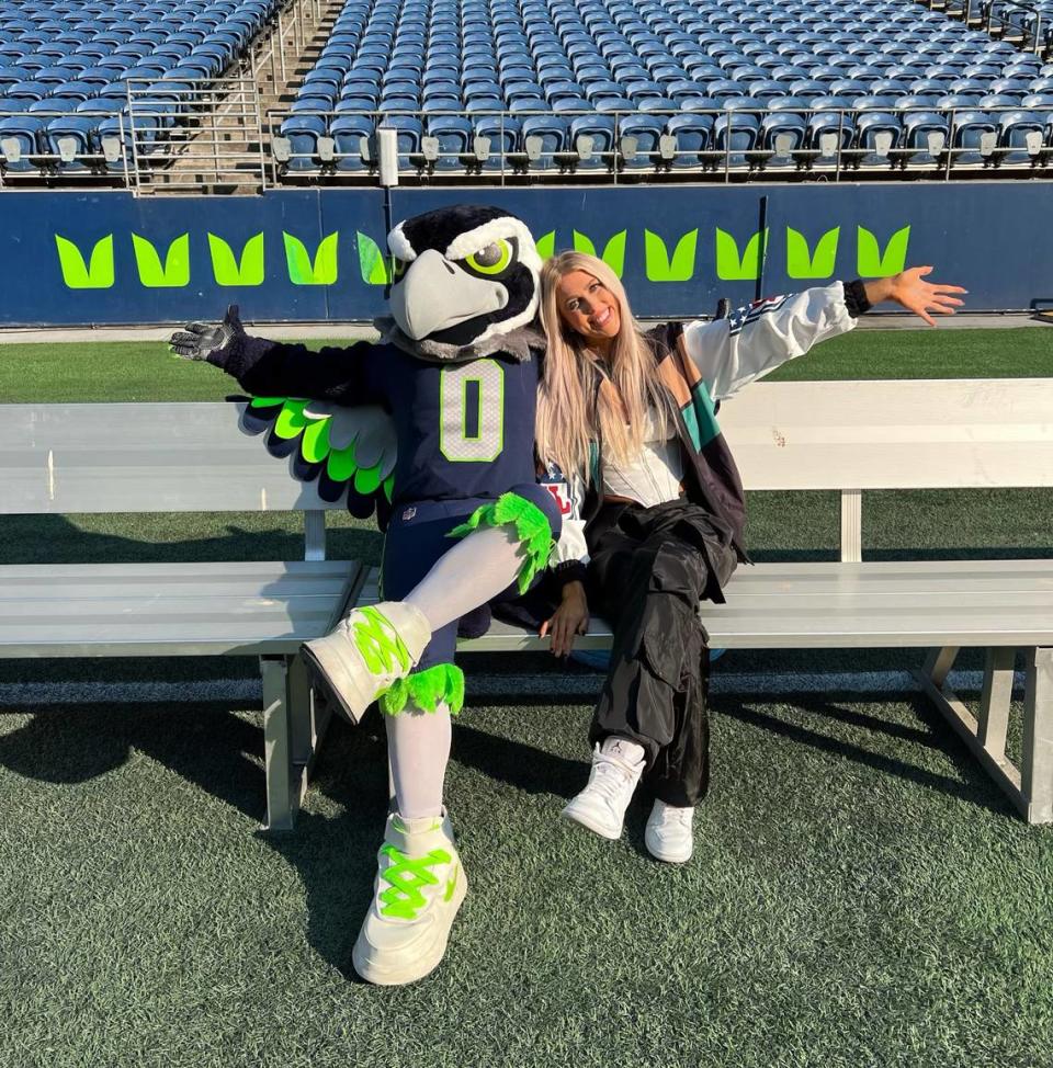 On her journey to NFL games, Lacey Jane Brown posed with plenty of mascots, including Blitz of the Seattle Seahawks at Lumen Field.