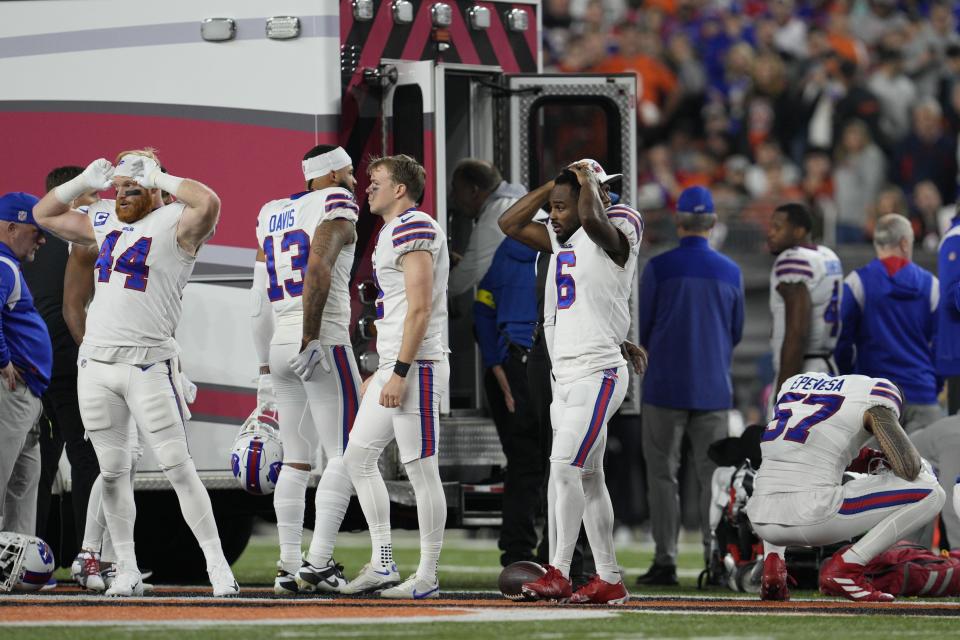 Buffalo Bills players react as their teammate, Damar Hamlin, is loaded into am ambulance on the field during a game against the Cincinnati Bengals on Jan, 2, 2023, in Cincinnati. (AP Photo/Jeff Dean)