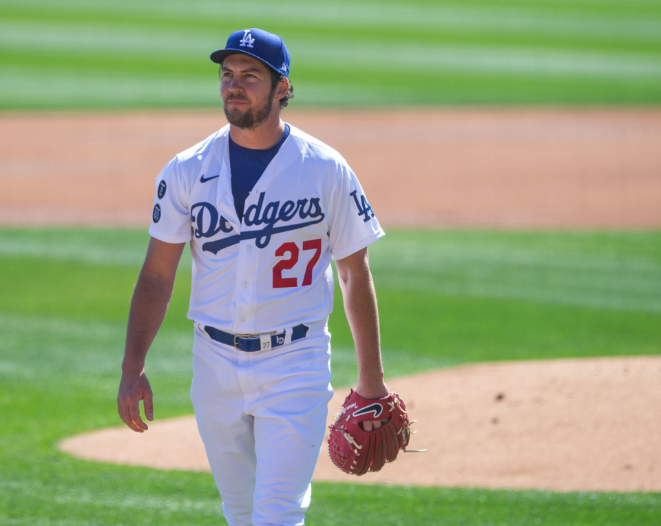 Dodgers pitcher Trevor Bauer stands on the field during a 2021 spring training game.