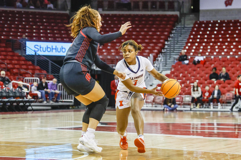 Illinois guard Makira Cook looks to pass the ball around Wisconsin guard Brooke Schramek during a women's college basketball game on Dec. 29, 2022 at the Kohl Center in Madison, Wisconsin. (Lawrence Iles/Icon Sportswire via Getty Images)