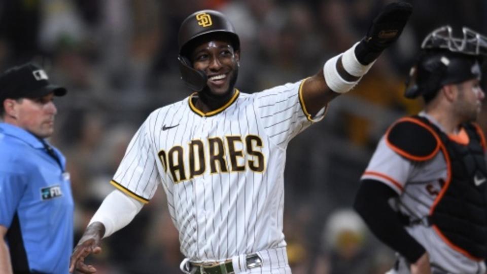 San Diego Padres left fielder Jurickson Profar (center) gestures after scoring a run on a single hit by third baseman Manny Machado (not pictured) during the third inning against the San Francisco Giants at Petco Park