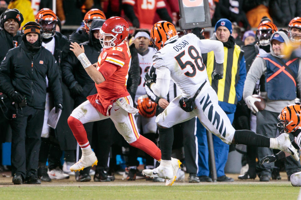 KANSAS CITY, MO - JANUARY 29: Kansas City Chiefs quarterback Patrick Mahomes (15) heads out of bounds in front of Cincinnati Bengals defensive end Joseph Ossai (58) during the last second of the game on January 29th, 2023 at Arrowhead Stadium in Kansas City, Missouri. (Photo by William Purnell/Icon Sportswire via Getty Images)