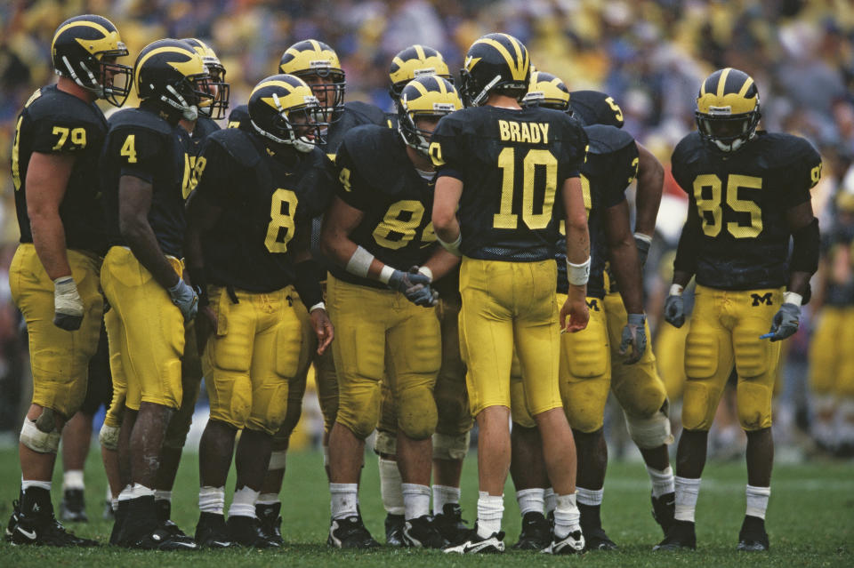 Tom Brady #10 Quarterback for the University of Michigan Wolverines instructs his offensive line in the huddle during the NCAA Division I-A Big 10 college football game against the Purdue University Boilermakers on 2nd October 1999 at the Michigan Stadium in Ann Arbor, Michigan, United States.The Michigan Wolverines won the game 38 - 12. (Photo by Harry How/Getty Images)