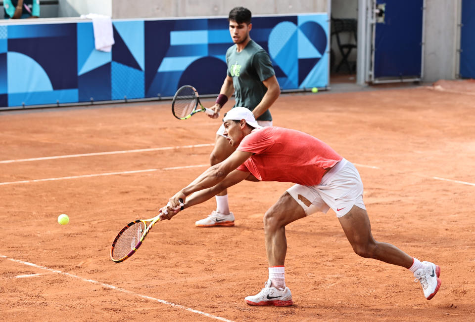 PARIS, FRANCE - JULY 24: Carlos Alcaraz and Rafael Nadal (R) of Spanish tennis team attend a training session at Stade Roland-Garros ahead of the Paris 2024 Olympic Games on July 24, 2024 in Paris, France. The Paris Olympics will be held from July 26 to August 11. (Photo by Bai Yu/CHINASPORTS/VCG via Getty Images)