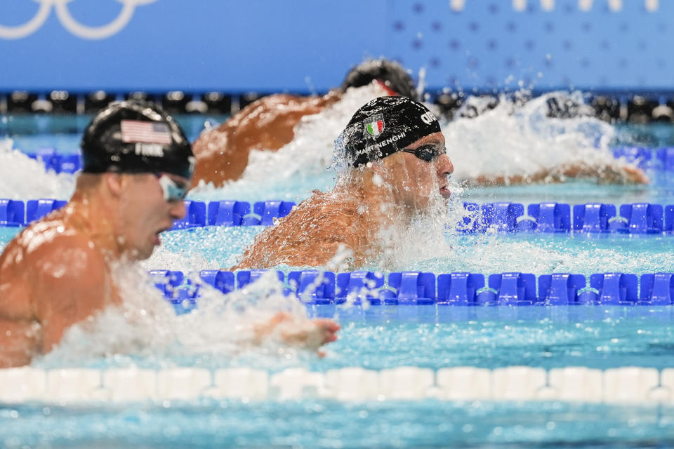 Nicolo Martinenghi, center, of Italy, competes in the men's 100-meter breaststroke final at the 2024 Summer Olympics, Sunday, July 28, 2024, in Nanterre, France. (AP Photo/Martin Meissner)