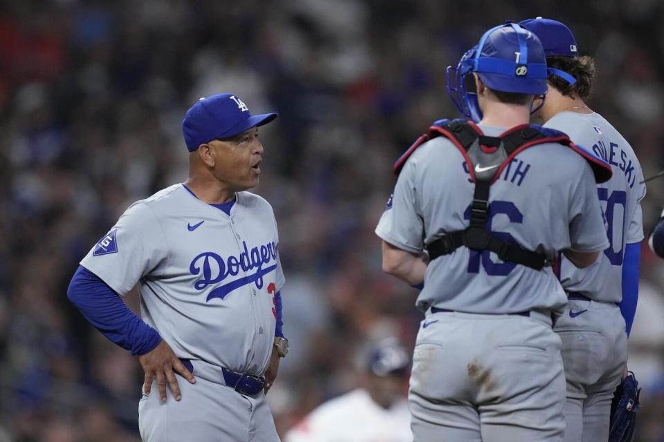 Dodgers manager Dave Roberts makes a pitching change during the sixth inning against the Astros on Saturday in Houston.