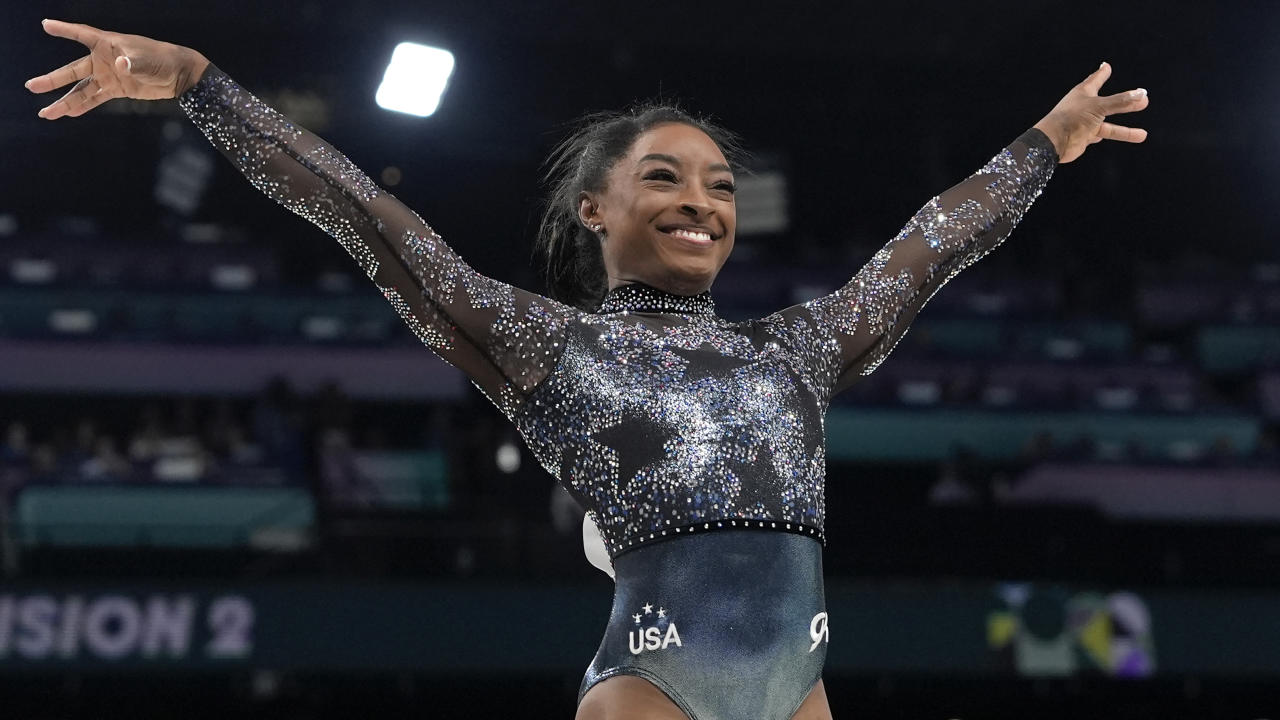 Simone Biles, of United States, smiles after competing on the vault during a women's artistic gymnastics qualification round at Bercy Arena at the 2024 Summer Olympics, Sunday, July 28, 2024, in Paris, France. (AP Photo/Charlie Riedel)