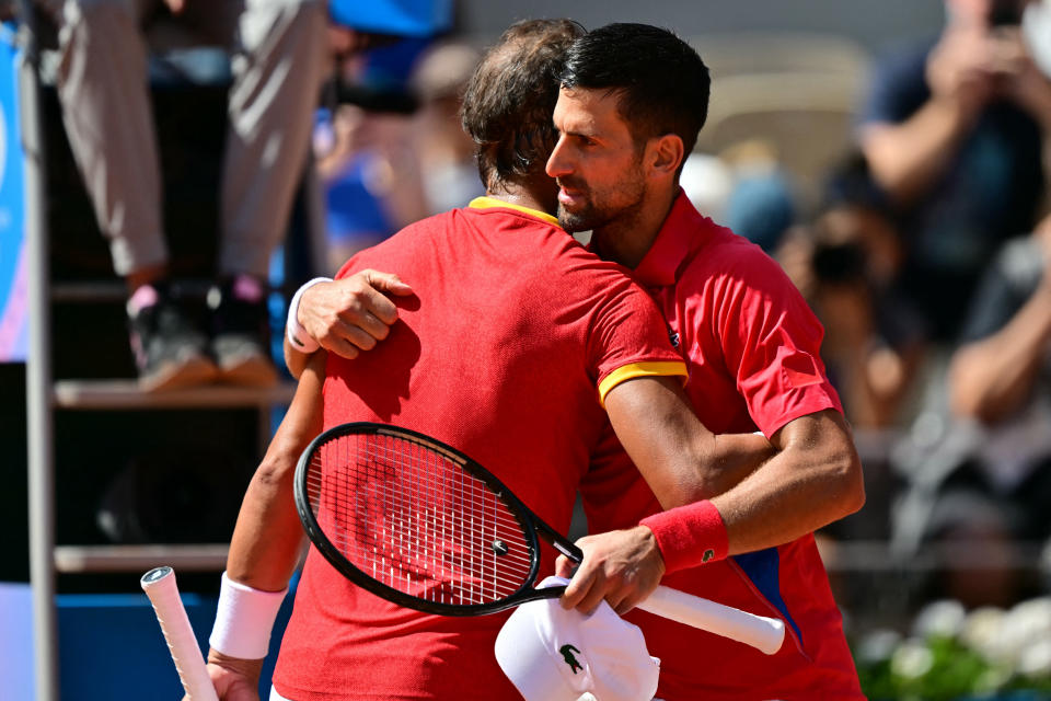 Winner, Serbia's Novak Djokovic (R) embraces Spain's Rafael Nadal (L) after their men's singles second round tennis match on Court Philippe-Chatrier at the Roland-Garros Stadium at the Paris 2024 Olympic Games, in Paris on July 29, 2024. (Photo by Martin BERNETTI / AFP) (Photo by MARTIN BERNETTI/AFP via Getty Images)