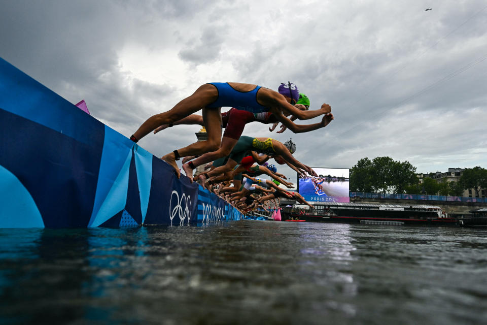 Athletes compete in the swimming race in the Seine during the women's individual triathlon at the Paris 2024 Olympic Games in central Paris on July 31, 2024. (Photo by MARTIN BUREAU / POOL / AFP) (Photo by MARTIN BUREAU/POOL/AFP via Getty Images)