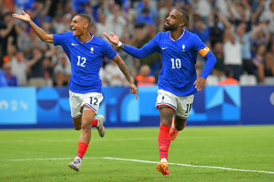 France's forward #10 Alexandre Lacazette (R) celebrates after scoring a goal next to France's midfielder #12 Enzo Millot during the men's group A football match between France and the USA as part of the Paris 2024 Olympic Games at the Marseille Stadium in Marseille on July 24, 2024. (Photo by NICOLAS TUCAT / AFP) (Photo by NICOLAS TUCAT/AFP via Getty Images)