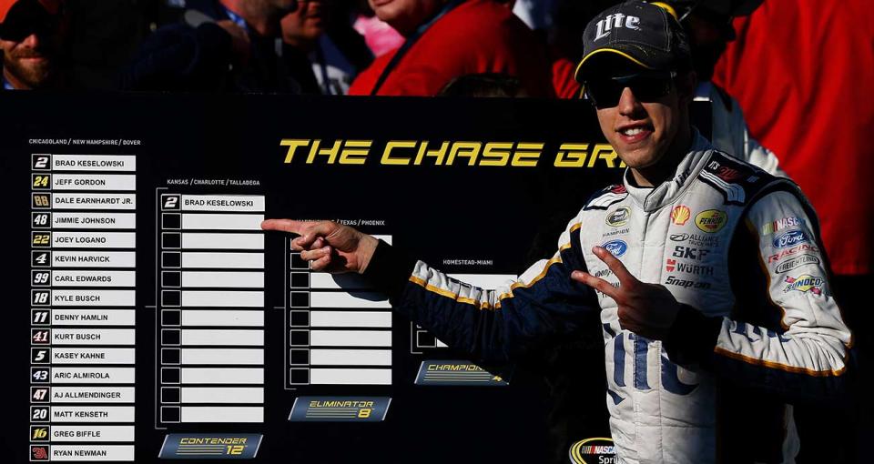 Brad Keselowski points at the Chase grid in Victory Lane at Chicagoland Speedway.