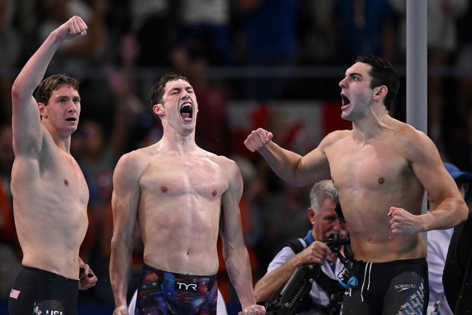 Gold medallists US' Caeleb Dressel, US' Hunter Armstrong, US' Chris Guiliano and US' Jack Alexy celebrate following the final of the men's 4x100m freestyle relay swimming event at the Paris La Defense Arena in Nanterre, west of Paris, on July 27, 2024. (Photo by SEBASTIEN BOZON / AFP) (Photo by SEBASTIEN BOZON/AFP via Getty Images)