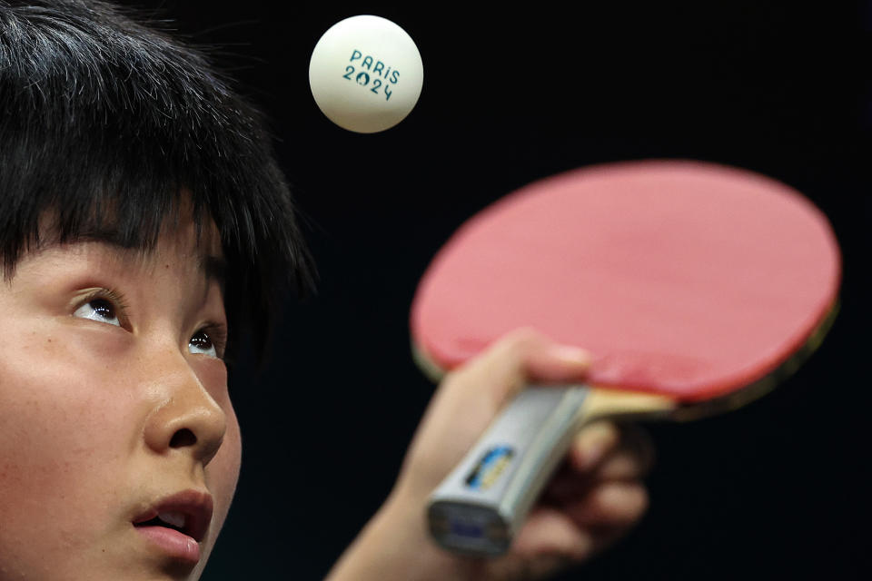 Kum Yong Kim of Team North Korea serves during a Mixed Doubles match against Team Japan on Saturday. (Steph Chambers/Getty Images)