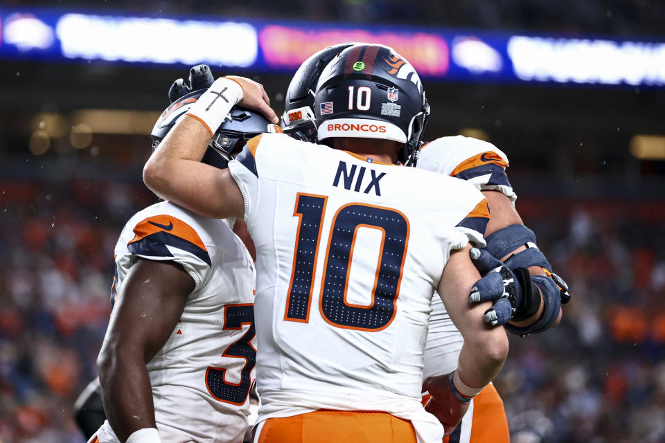 DENVER, COLORADO - AUGUST 18: Bo Nix #10 of the Denver Broncos celebrates with teammates in the first half of the preseason game against the Green Bay Packers at Empower Field At Mile High on August 18, 2024 in Denver, Colorado. (Photo by Tyler Schank/Getty Images)