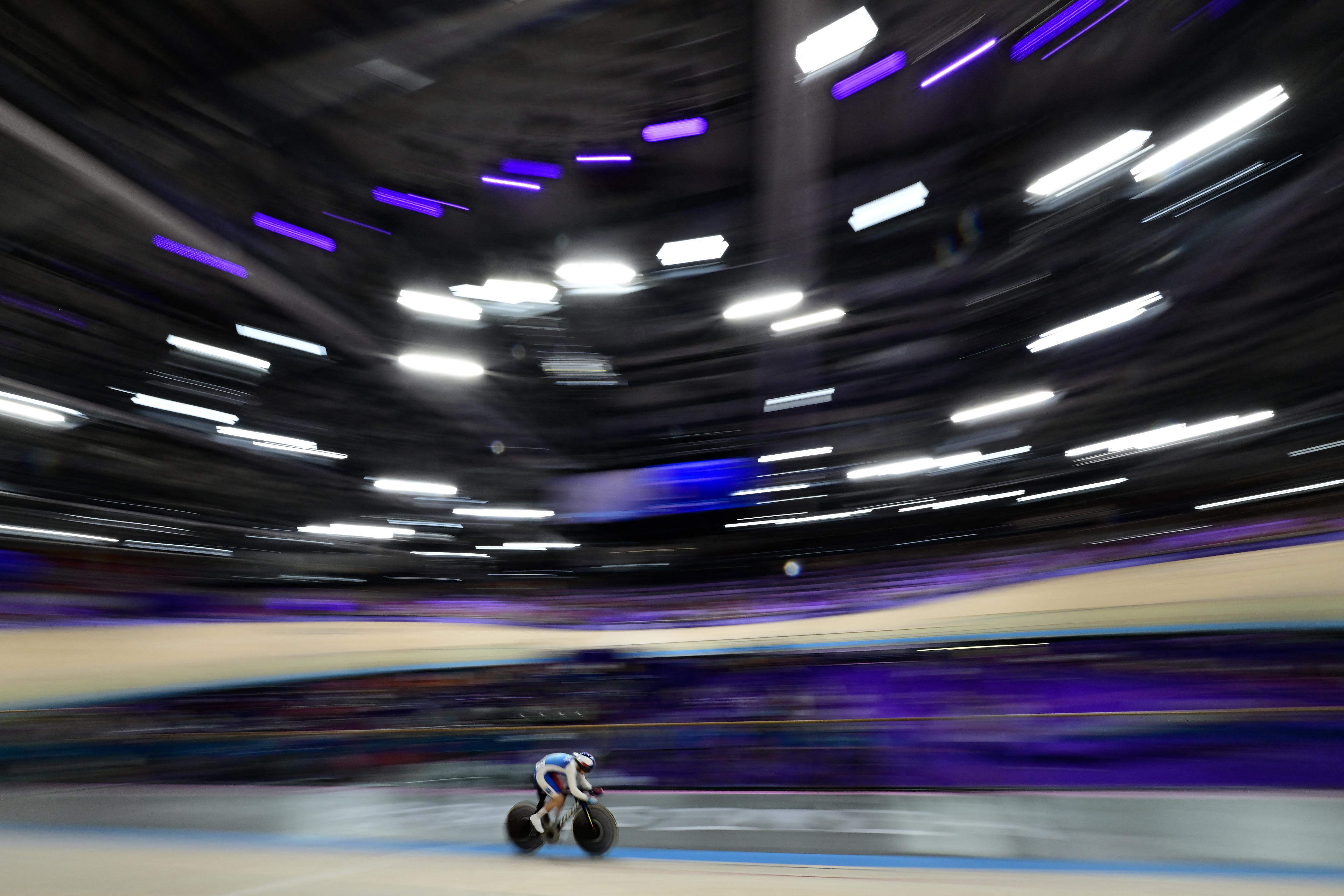 France's Mathilde Gros competes in a women's track cycling sprint qualifying round of the Paris 2024 Olympic Games at the Saint-Quentin-en-Yvelines National Velodrome in Montigny-le-Bretonneux, south-west of Paris, on August 9, 2024. (John MacDougall/AFP/Getty Images)