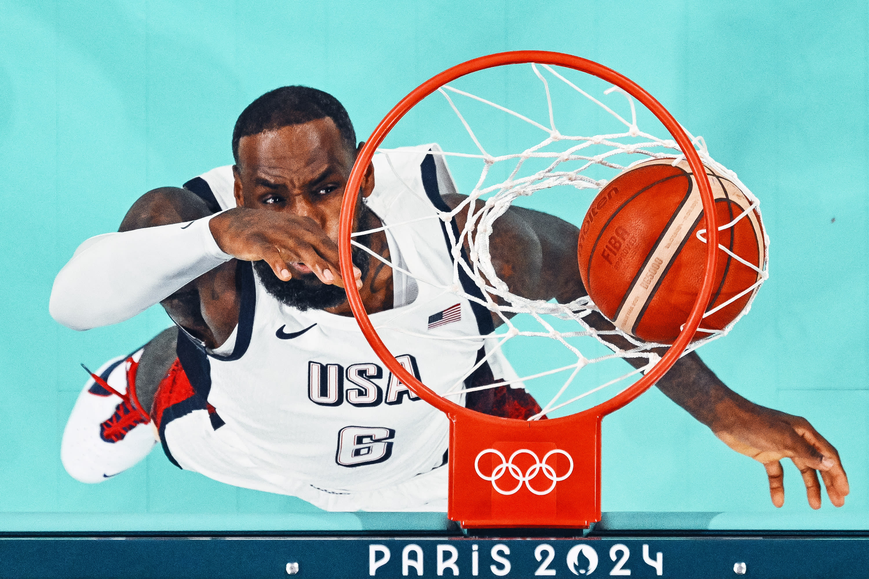 An overview shows USA's #06 LeBron James scores a basket in the men's preliminary round group C basketball match between USA and South Sudan during the Paris 2024 Olympic Games at the Pierre-Mauroy stadium in Villeneuve-d'Ascq, northern France, on July 31, 2024. (Photo by SAMEER AL-DOUMY/POOL/AFP via Getty Images) 