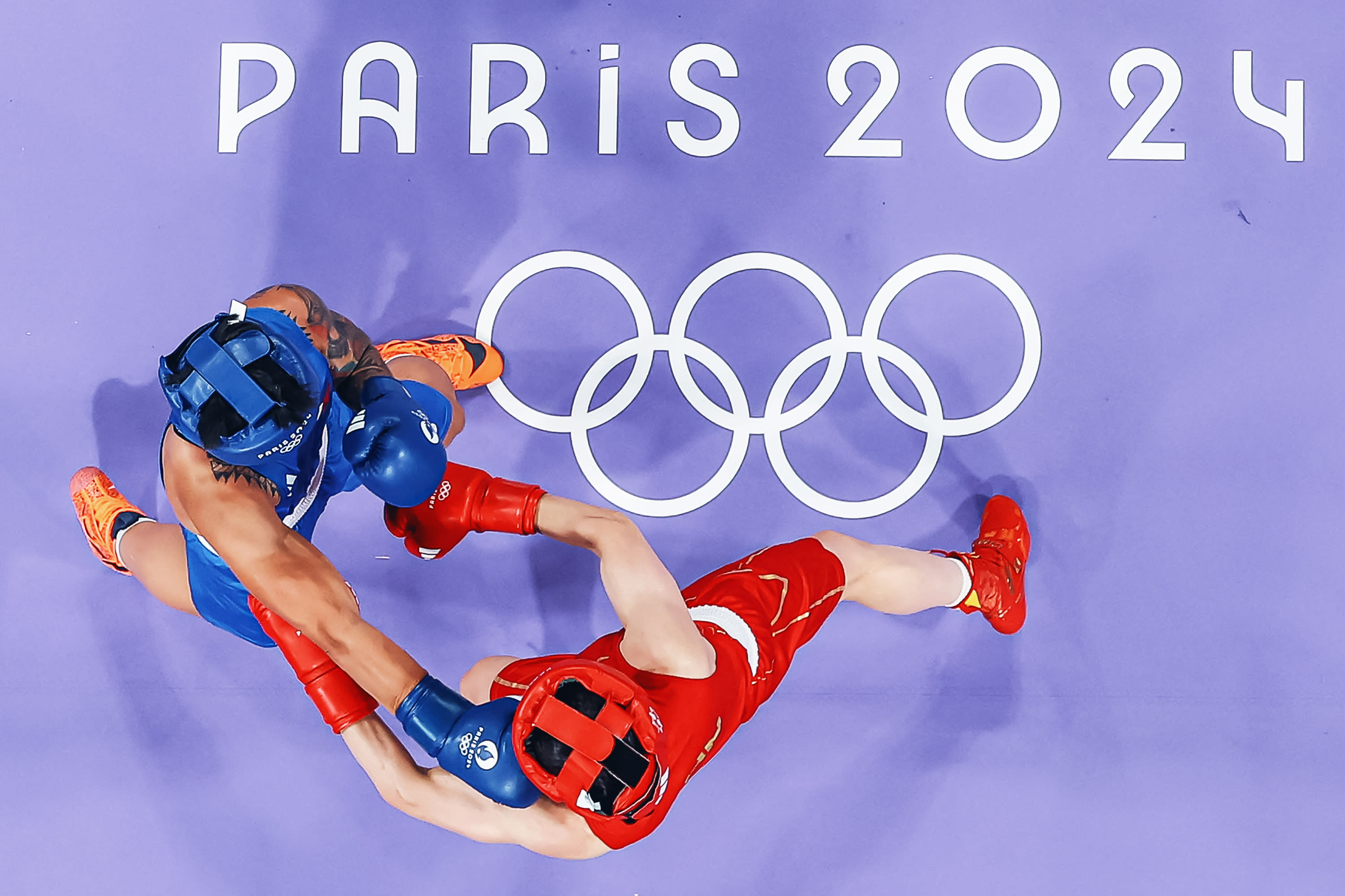 An overview shows Philippines' Hergie Bacyadan (in blue) fighting against China's Li Qian in the women's 75kg preliminaries round of 16 boxing match during the Paris 2024 Olympic Games at the North Paris Arena, in Villepinte on July 31, 2024. (Photo by -/POOL/AFP via Getty Images) 