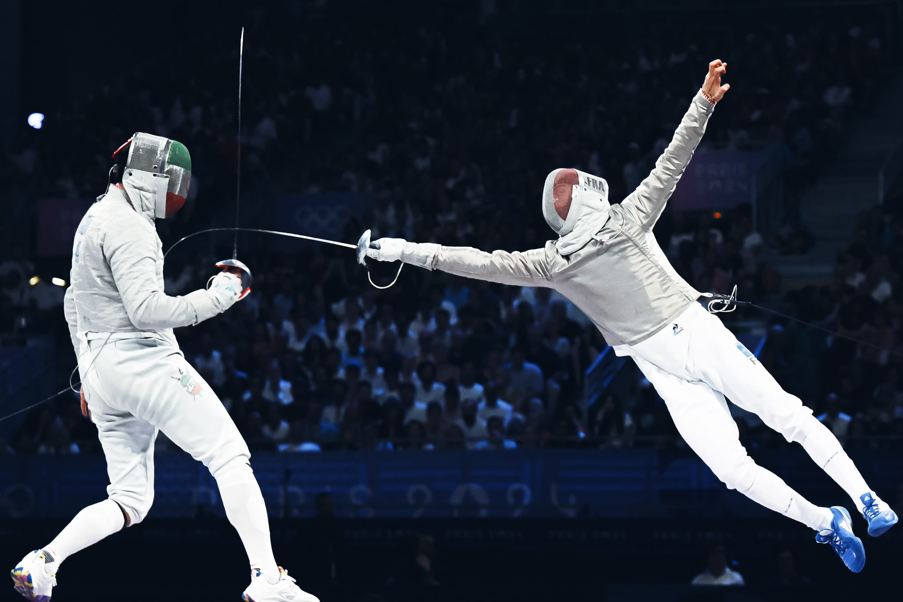 Iran's Mohammad Rahbari Koyakhi (L) competes against France's Sebastien Patrice in the men's sabre team bronze medal bout between Iran and France during the Paris 2024 Olympic Games at the Grand Palais in Paris, on July 31, 2024. (Photo by FABRICE COFFRINI/AFP via Getty Images) 