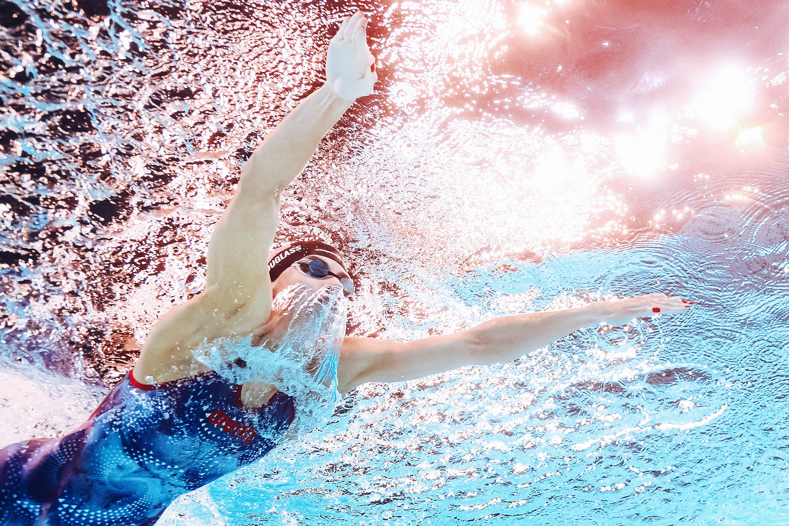 An underwater view shows USA's Kate Douglass competing in the final of the women's 200m breaststroke swimming event during the Paris 2024 Olympic Games at the Paris La Defense Arena in Nanterre, west of Paris on August 1, 2024. (Photo by MANAN VATSYAYANA/AFP via Getty Images) 