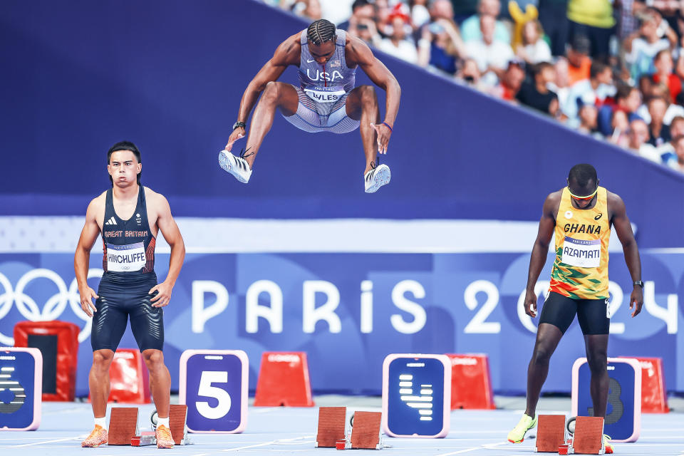 Noah Lyles shows off his hops while warming up for Sunday's 100-meter semifinal. (Christian Petersen/Getty Images)