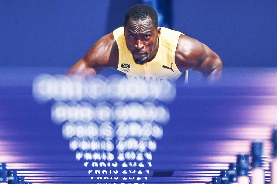 Jamaica's Hansle Parchment prepares to take the start in the men's 110m hurdles heat of the athletics event at the Paris 2024 Olympic Games at Stade de France in Saint-Denis, north of Paris, on August 4, 2024. (Photo by Jewel SAMAD / AFP) (Photo by JEWEL SAMAD/AFP via Getty Images)