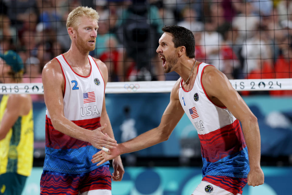 Chase Budinger and Miles Evans rolled over Australia on Saturday night to make the beach volleyball knockout round.