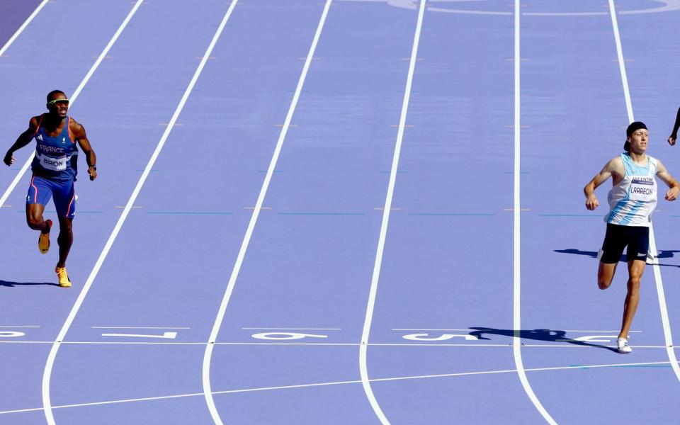 Gilles Biron (L) of France, Elian Larregina (C) of Argentina and Lucas Carvalho of Brazil cross the finish line in heat 1 in the Men 400m repechage of the Athletics competitions in the Paris 2024 Olympic Games, at the Stade de France stadium in Saint Denis, France