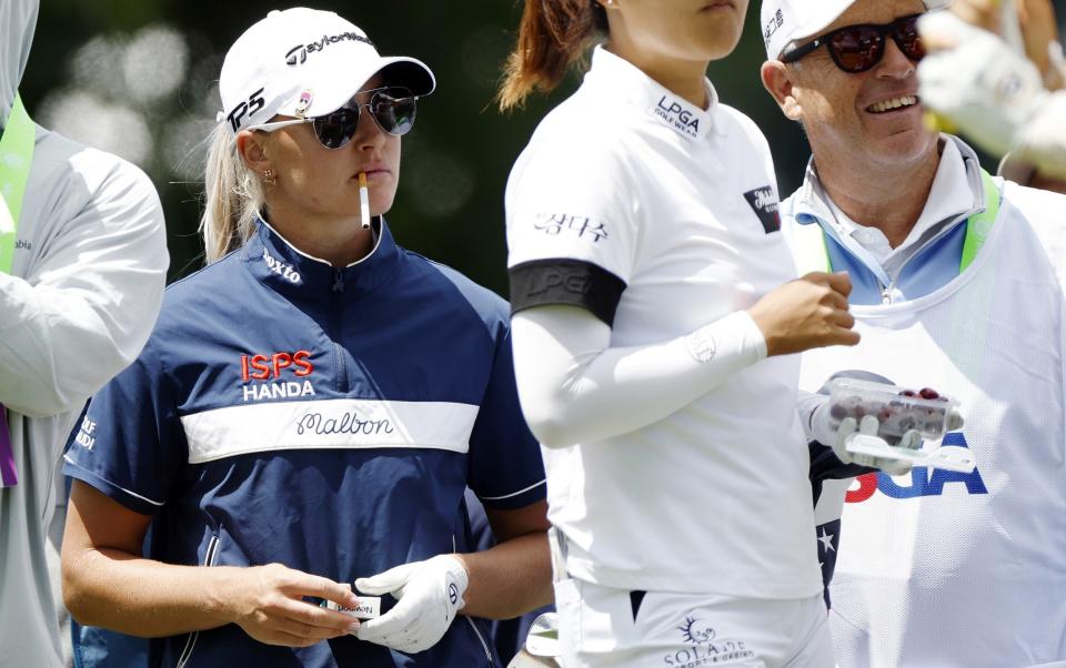 Charley Hull of England smokes a cigarette on the ninth tee during the first round of the U.S. Women's Open Presented by Ally at Lancaster Country Club on May 30, 2024 in Lancaster, Pennsylvania