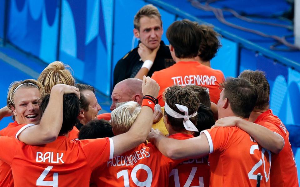 The rest of the Dutch team celebrate, oblivious to what is happening behind them