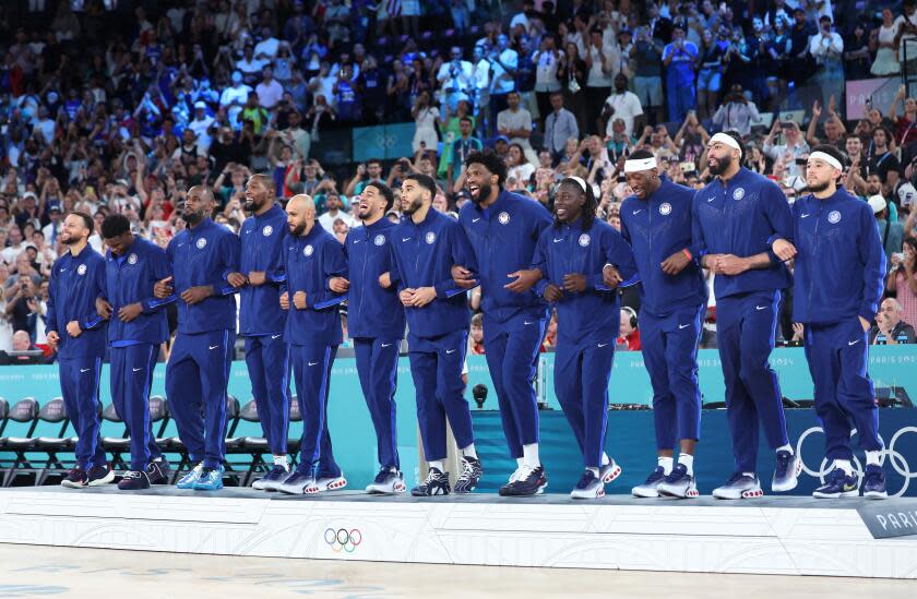 American basketball players celebrate their win against France in the gold-medal match Saturday in Paris.