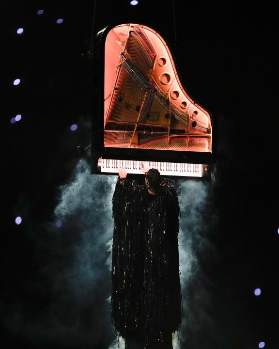 Artist Alain Roche plays a piano during the 2024 Summer Olympics closing ceremony at the Stade de France, Sunday, Aug. 11, 2024, in Saint-Denis, France. (AP Photo/Ashley Landis)