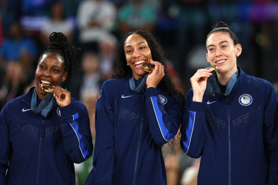 PARIS, FRANCE - AUGUST 11: Gold medalists Chelsea Gray, A'Ja Wilson, and Breanna Stewart of Team United States pose for a photo on the podium during the Women's basketball medal ceremony on day sixteen of the Olympic Games Paris 2024 at Bercy Arena on August 11, 2024 in Paris, France. (Photo by Gregory Shamus/Getty Images)