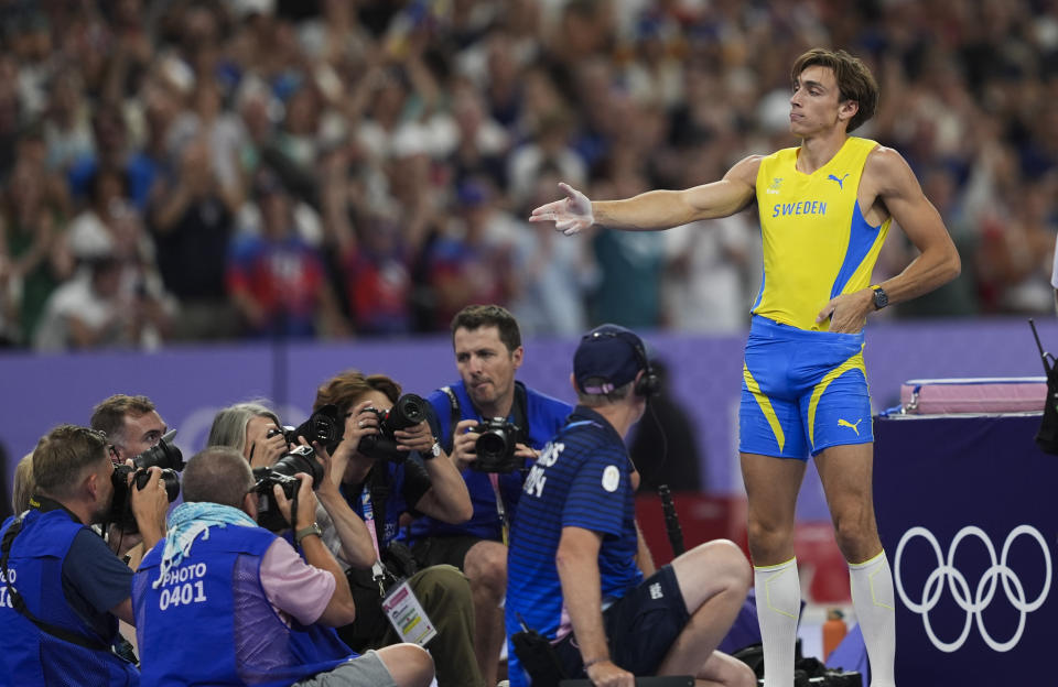 PARIS, FRANCE - AUGUST 05: Sweden's Armand Duplantis celebrates his victory with the famous shooting pose of Turkish Olympic silver medalist shooter Yusuf Dikec after passing 6.10m and setting the new Olympic record in the men's pole vault final of the athletics event at the Paris 2024 Olympic Games at Stade de France in Saint-Denis, north of Paris, on August 5, 2024. (Photo by Mustafa Ciftci/Anadolu via Getty Images)