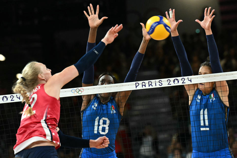 Italy's #18 Paola Ogechi Egonu and Italy's #11 Anna Danesi jump to stop a ball from US' #22 Kathryn Plummer in the women's volleyball gold medal match between USA and Italy at the South Paris Arena 1 in Paris during the Paris 2024 Olympic Games on August 11, 2024. (Photo by Natalia KOLESNIKOVA / AFP) (Photo by NATALIA KOLESNIKOVA/AFP via Getty Images)