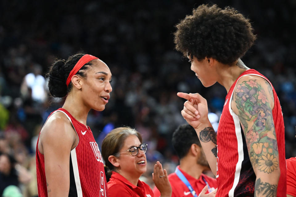 USA's #09 A'ja Wilson (L) and USA's #15 Brittney Griner react after winning the women's Gold Medal basketball match between France and the USA during the Paris 2024 Olympic Games at the Bercy Arena in Paris on August 11, 2024. (Photo by Paul ELLIS / AFP) (Photo by PAUL ELLIS/AFP via Getty Images)