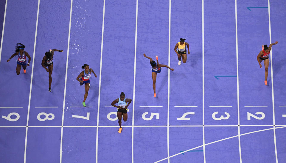 St Lucia's Julien Alfred crosses the finish line, followed by US' Sha'Carri Richardson and Melissa Jefferson in the women's 100m final of the athletics event at the Paris 2024 Olympic Games at Stade de France in Saint-Denis, north of Paris, on August 3, 2024. (Photo by Jewel SAMAD / AFP) (Photo by JEWEL SAMAD/AFP via Getty Images)