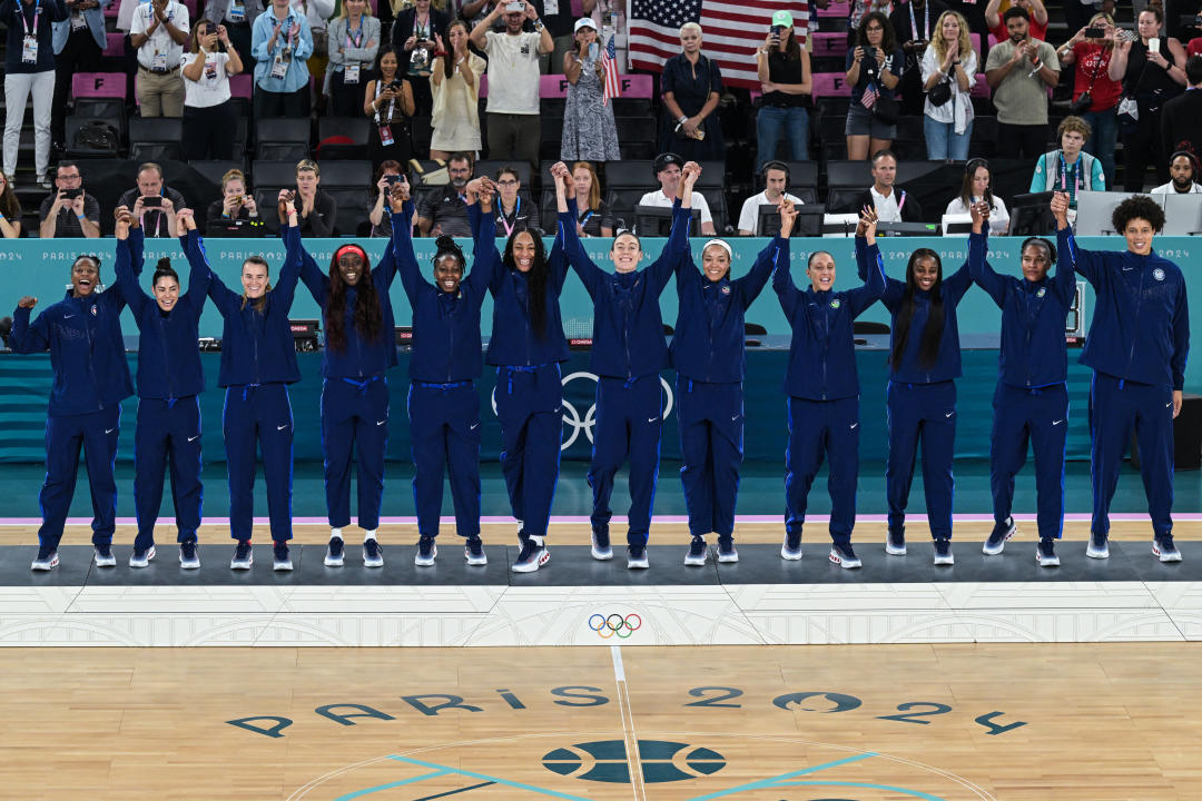 Gold medallists USA stand on the podium after the women's Gold Medal basketball match between France and the USA during the Paris 2024 Olympic Games at the Bercy Arena in Paris on August 11, 2024. (Photo by Damien MEYER / AFP) (Photo by DAMIEN MEYER/AFP via Getty Images)