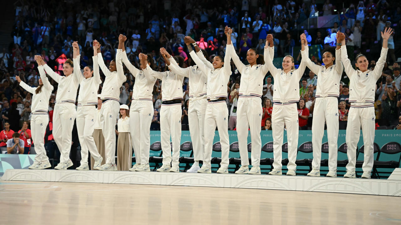 Silver medallists France celebrate on the podium after the women's Gold Medal basketball match between France and the USA during the Paris 2024 Olympic Games at the Bercy Arena in Paris on August 11, 2024. (Photo by Paul ELLIS / AFP) (Photo by PAUL ELLIS/AFP via Getty Images)