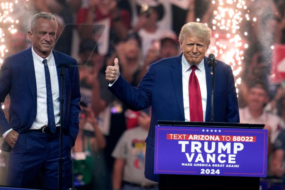 Independent presidential candidate Robert F. Kennedy Jr., left, looks on as Republican presidential nominee former President Donald Trump speaks at a campaign rally Friday, Aug. 23, 2024, in Glendale, Ariz. (AP Photo/Ross D. Franklin) (AP)