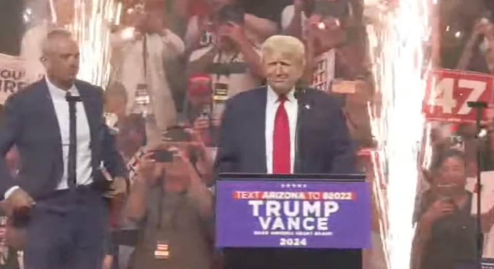 Trump welcomes RFK Jr on stage at his rally in Glendale, Arizona after the Independent dropped out of the presidential race and endorsed the former president (AP)