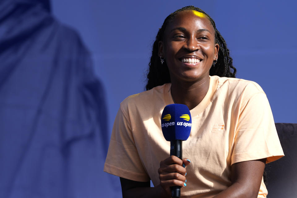 Coco Gauff smiles while speaking to the crowd at the US Open Fan Week at the USTA Billie Jean King National Tennis Center in New York, Tuesday, Aug. 20, 2024. (AP Photo/Pamela Smith)