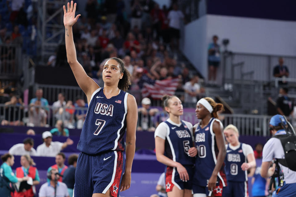 US' #07 Cierra Burdick and her teammates celebrate after winning the women's 3x3 basketball bronze medal game between Canada and USA during the Paris 2024 Olympic Games at La Concorde in Paris on August 5, 2024. (Photo by David GRAY / AFP) (Photo by DAVID GRAY/AFP via Getty Images)