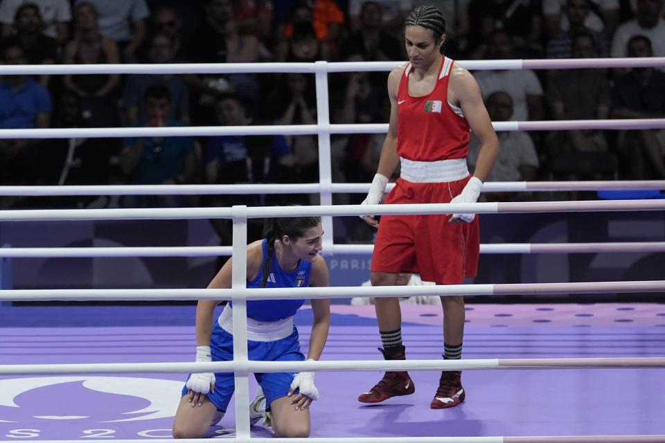 Algeria's Imane Khelif, right, defeated, Italy's Angela Carini in their women's 66kg preliminary boxing match at the 2024 Summer Olympics, Thursday, Aug. 1, 2024, in Paris, France. (AP Photo/John Locher)