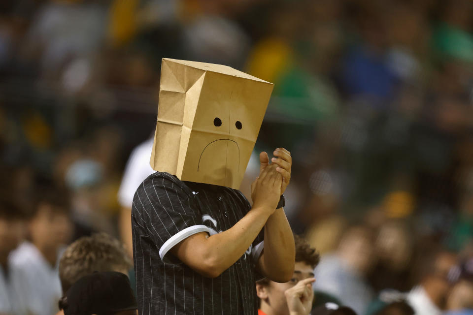 OAKLAND, CALIFORNIA - AUGUST 06: A spectator wearing a paper bag on their head claps after the Chicago White Sox record an out in the bottom of the eighth inning against the Oakland Athletics at Oakland Coliseum on August 06, 2024 in Oakland, California. (Photo by Lachlan Cunningham/Getty Images)