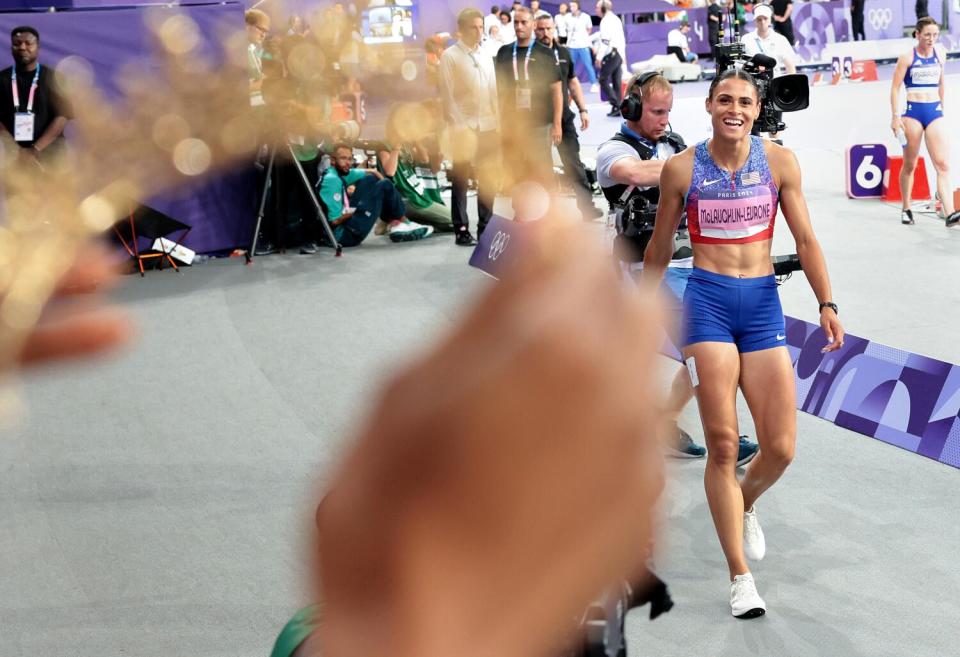 -USA's Sydney McLaughlin-Levrone receives a crown from her sister after winning the