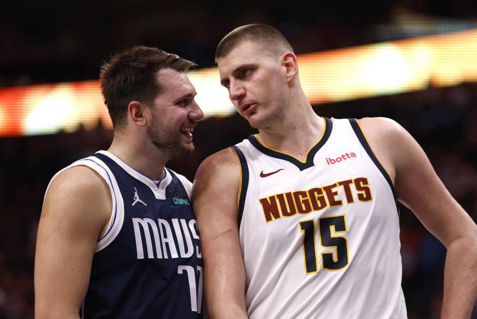 Luka Doncic #77 of the Dallas Mavericks and Nikola Jokic #15 of the Denver Nuggets