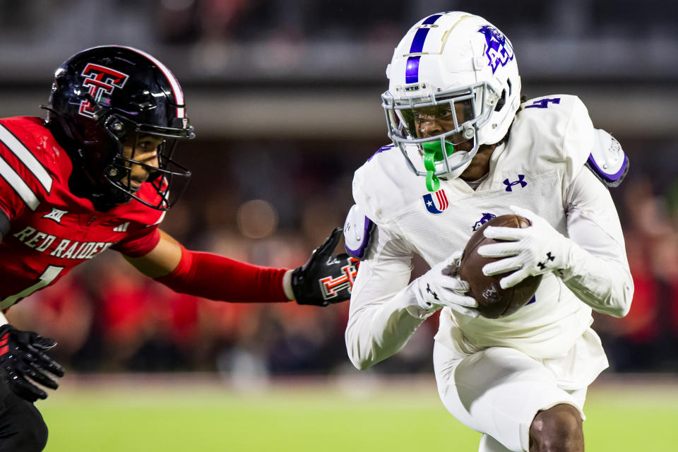 LUBBOCK, TEXAS - AUGUST 31: J.J. Henry #4 of the Abilene Christian Wildcats runs with the ball against A.J. McCarty #1 of the Texas Tech Red Raiders during the second half of the game at Jones AT&T Stadium on August 31, 2024 in Lubbock, Texas. (Photo by John E. Moore III/Getty Images)